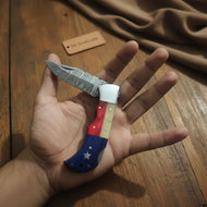 Handmade Damascus Folding Knife – Tricolor Resin Handle (Red, White & Blue) with Leather Sheath